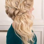 A woman with long blonde hair in a half updo with a side swept braid, perfect for a Quinceanera celebration