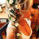 Quinceanera image: Cami DiGirolamo with a flower in her hair in a stylish hairstyle