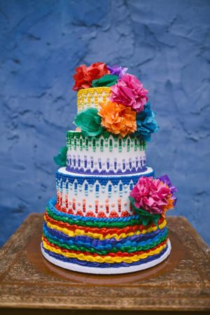 Quinceanera cake, a multicolored cake with flowers on top, with a Mexican theme