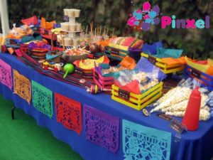 A Quinceanera table decorated with colorful charro decorations