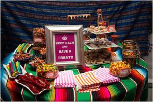 A confectionery Quinceañera with a table topped with lots of food and candy