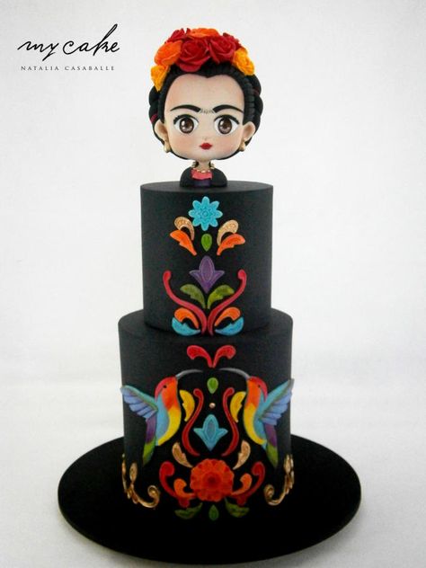 A Quinceanera cake featuring a Frida doll on top of a black cake