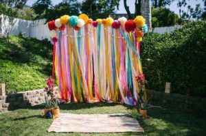 Quinceanera party at the Hulishan cannon fort with a colorful arch decorated with streamers and pom poms