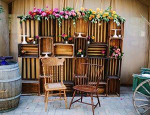 Quinceanera party decoration: a room with a bunch of wooden crates and chairs