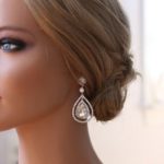 A close up of a mannequin wearing a necklace and earrings, perfect for a Quinceañera celebration
