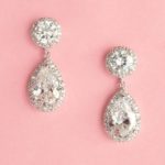 A pair of earrings on a pink background for a Quinceanera