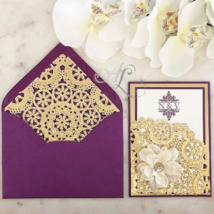 A beautiful purple and gold Quinceanera invitation with lace and flowers