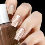 A Quinceanera themed image featuring a woman with white and brown manicured nails, holding a bottle of nail polish