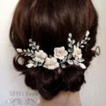 A close up of a woman wearing a Quinceanera hair comb and jewellery hairstyle.