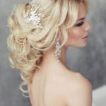 A woman in a Quinceanera dress with a hair comb, showcasing a cascading hairstyle