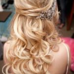 Quinceanera hairstyles for medium length hair half up, a woman with long blonde hair wearing a tiara