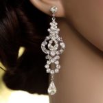 A close up of a woman wearing a pair of Quinceanera earrings