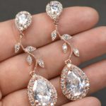 Quinceanera earrings, a person holding a pair of Korean earrings in their hand