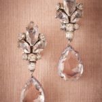 A pair of Quinceanera earrings sitting on a table