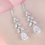 A pair of Quinceanera earrings on a pink background