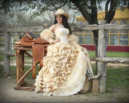 Quinceanera dresses with hats - A woman in a dress and hat sitting on a bench