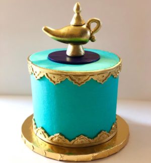 Quinceanera cake, a blue and gold cake with a lamp on top