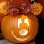 Quinceanera theme: A close-up of a pumpkin with a carved face, perfect for mice pumpkin decorating ideas at a Quinceanera celebration.