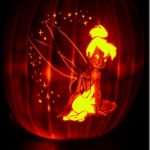 A Quinceañera themed image featuring a Tinker Bell pumpkin carving with a fairy sitting on top of it
