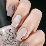 Quinceanera: A woman holding a bottle of OPI nail polish