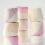 A stack of four lilac marshmallows sitting on top of each other in a Quinceanera themed image.