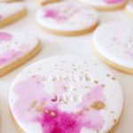 A close up of some Quinceanera cookies on a table with royal icing