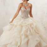 A beautiful Quinceanera dress inspired by the Great Gatsby theme. A woman wearing a Quinceanera dress poses for a picture.