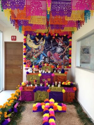 Quinceanera image: A room decorated with colorful decorations and flowers, inspired by Day of the Dead