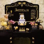 Quinceanera celebration: A black table adorned with a birthday cake and cupcakes for a 65th birthday decoration party