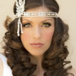 A woman with long blonde hair wearing a blue dress and 1920s hairstyle for Quinceanera