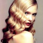 Quinceanera hairstyle - Jessica Rabbit inspired. A woman with long blonde hair is posing for a picture.