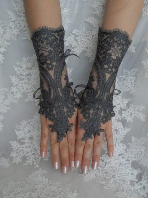 A Quinceanera image featuring a woman's hands decorated with black lace and a copper-colored background at the da arlete kiosk.