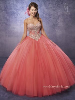 A woman in a ball gown posing for a picture in gown Quinceañera dresses
