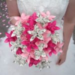 A Quinceanera holding a bouquet of pink and white flowers