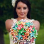 Quinceanera: A woman holding a paper flower bouquet