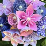 A beautiful bouquet of cut flowers and paper flowers with pearls and pearls, perfect for a Quinceanera celebration.