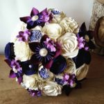 Quinceanera floral design, a bouquet of flowers sitting on top of a wooden table