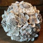Quinceanera flower bouquet, a bouquet of paper flowers sitting on a table