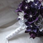 A Quinceanera bouquet of cut flowers, featuring a mix of purple and white flowers