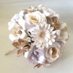 Quinceanera flower bouquet, a bouquet of white flowers made of origami on a table