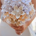 A quinceanera holding a bouquet of flowers in her hands