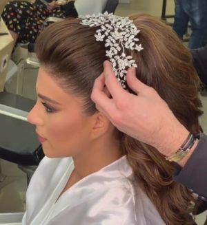 Quinceanera: A woman getting her hair done in a chignon at a salon
