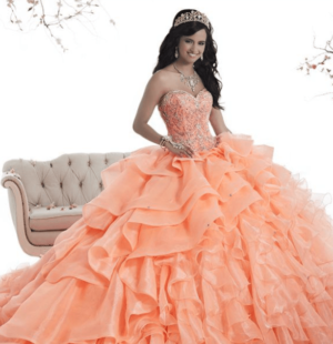 Coral Quinceañera dresses, a woman in a ball gown posing for a picture