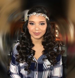 Quinceanera woman with long hair wearing a headpiece and a headband