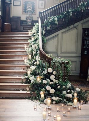 A staircase decorated with flowers and candles, perfect for a Quinceanera celebration
