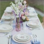 A watercolor Quinceanera theme with a table set with plates and silverware