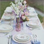 A watercolor Quinceanera theme with a table set with plates and silverware