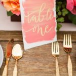 A Quinceanera decoracion boda color coral Wedding Dress, featuring a table setting with gold cutlery and pink flowers