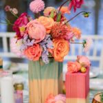 A table topped with a vase filled with flowers and cut flowers in a floral design, perfect for a Quinceanera celebration.