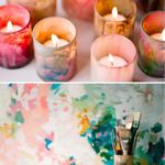 A table topped with beautiful candles, including lots of different colored candles